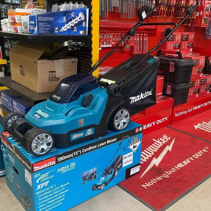 Makita 380mm cordless lawn mower on display beside Milwaukee toolboxes